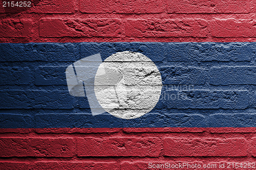 Image of Brick wall with a painting of a flag, Laos