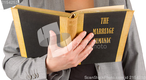 Image of Woman reading a marriage almanac