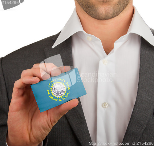 Image of Businessman is holding a business card, South Dakota