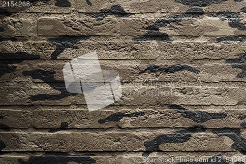 Image of Brick wall with a painting of a flag, camouflage