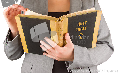 Image of Woman in business suit is reading a holy bible