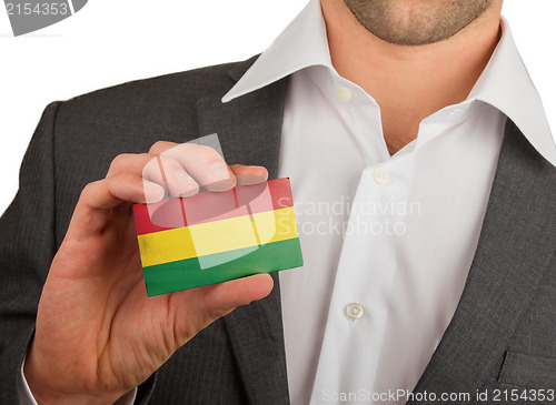 Image of Businessman is holding a business card, Bolivia