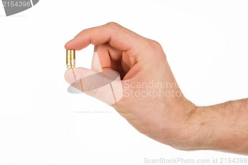 Image of Hand holding an empty bullet shell