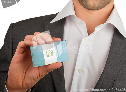 Image of Businessman is holding a business card, Guatamala