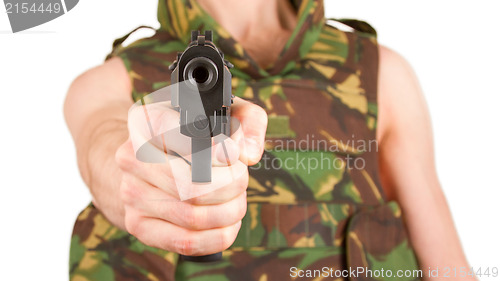 Image of Soldier in camouflage vest is holding a gun