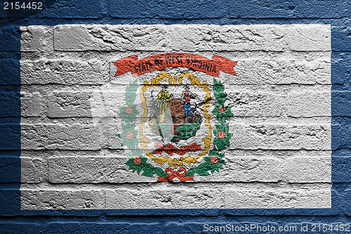 Image of Brick wall with a painting of a flag, West Virginia