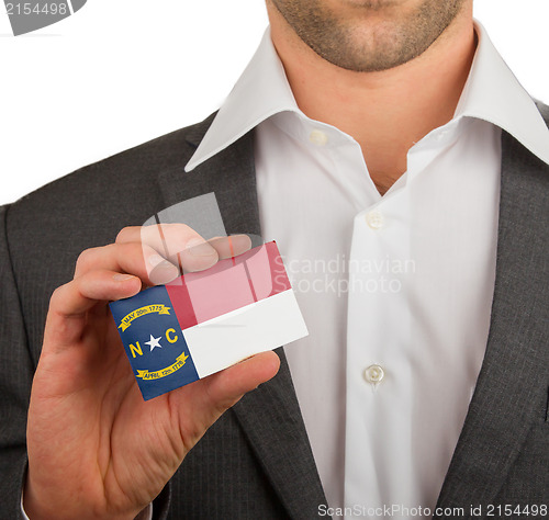 Image of Businessman is holding a business card, North Carolina