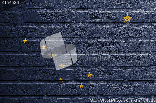 Image of Brick wall with a painting of a flag, Alaska
