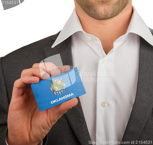 Image of Businessman is holding a business card, Oklahoma