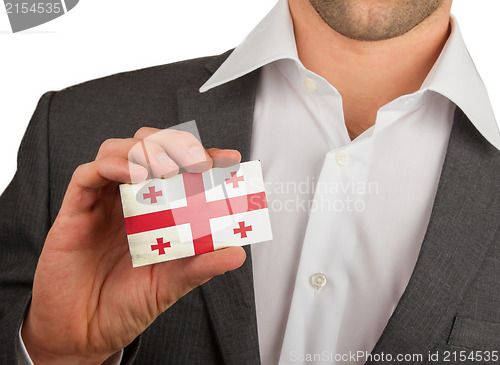Image of Businessman is holding a business card, Georgia