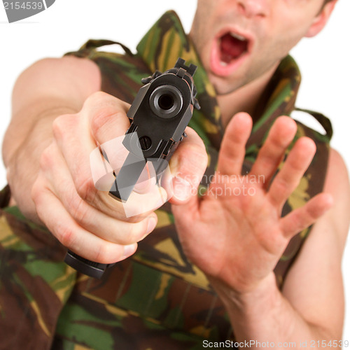 Image of Soldier in camouflage vest is holding a gun