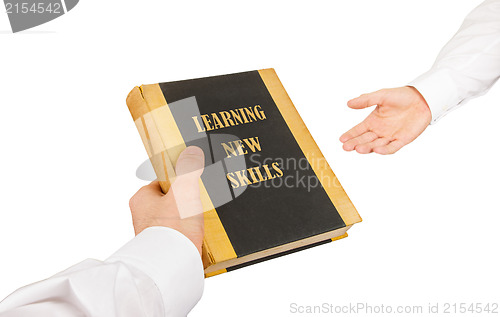 Image of Businessman giving a book to another businessman