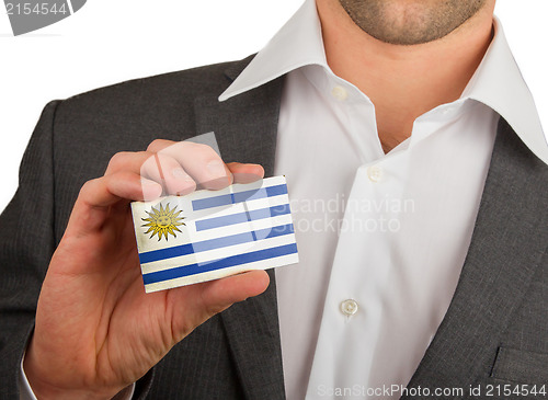 Image of Businessman is holding a business card, Uruguay