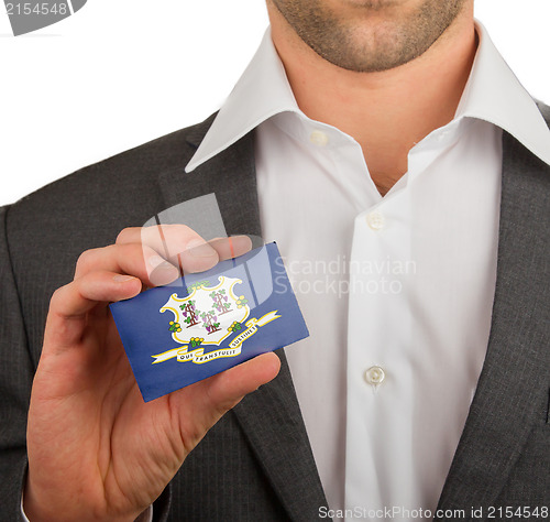Image of Businessman is holding a business card, Connecticut