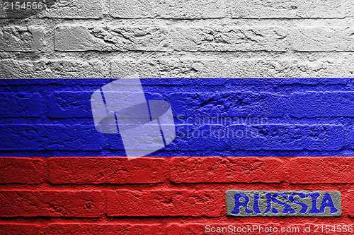 Image of Brick wall with a painting of a flag