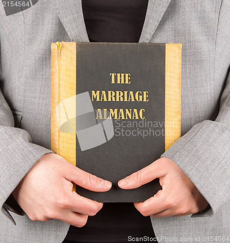 Image of Woman holding a marriage almanac