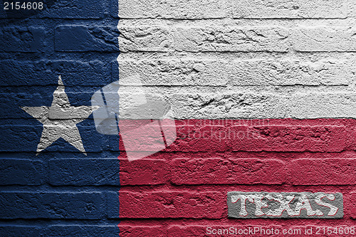 Image of Brick wall with a painting of a flag, Texas