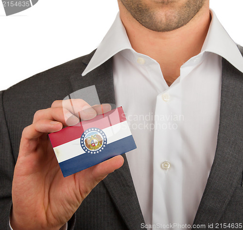 Image of Businessman is holding a business card, Missouri