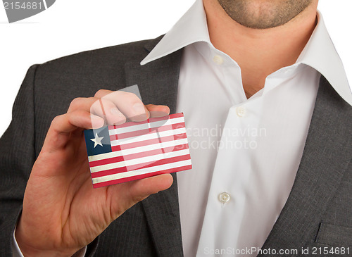 Image of Businessman is holding a business card, Liberia