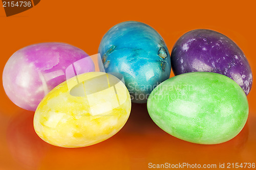 Image of Easter eggs in different colors on an orange background