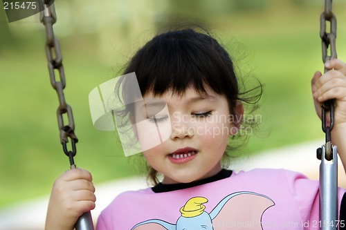 Image of Baby girl swinging