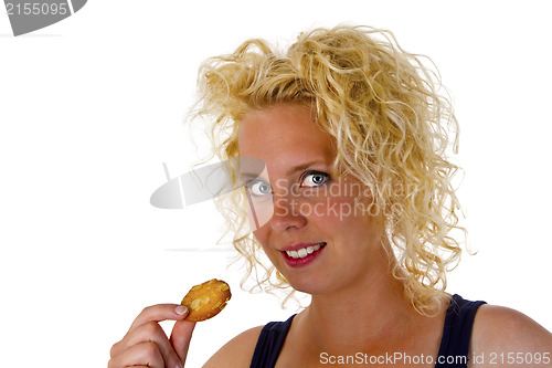 Image of Young woman eating cookie