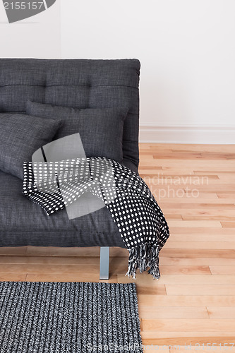 Image of Gray sofa with cushions and throw 