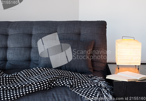 Image of Cozy gray sofa, table lamp and book