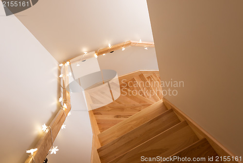 Image of Lights decorating wooden staircase