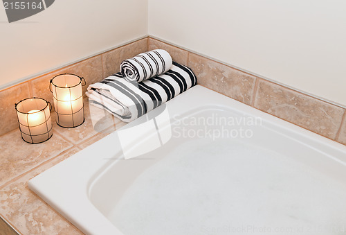 Image of Towels, cozy lanterns and bath with foam
