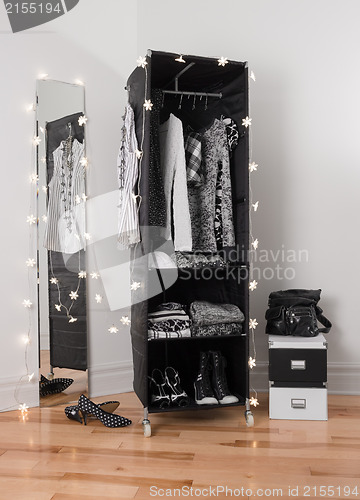 Image of Clothes organizer and mirror decorated with lights