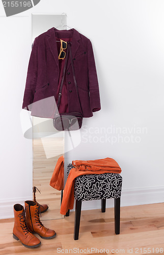 Image of Purple jacket hanging on a mirror