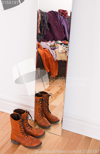 Image of Clothes and shoes reflecting in the mirror 
