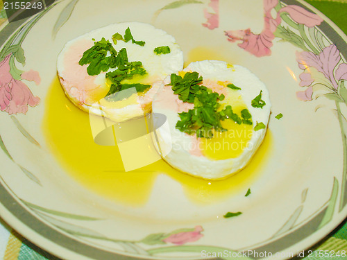 Image of Tomino cheese with rucola and olive oil