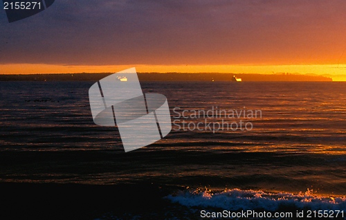 Image of Sunset and freighters