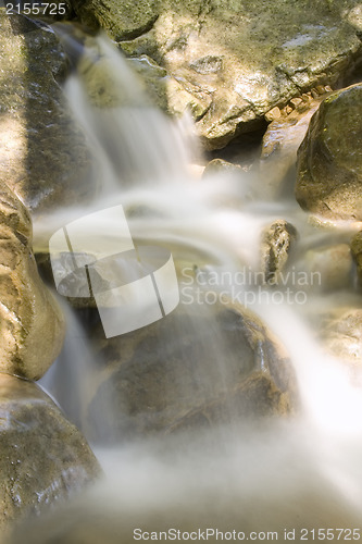 Image of Water stream falling on a rock.Long exposure is used.