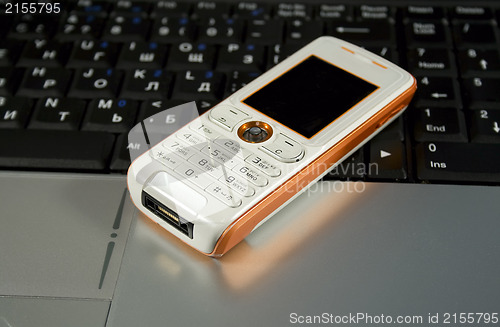 Image of Mobile phone on a laptop