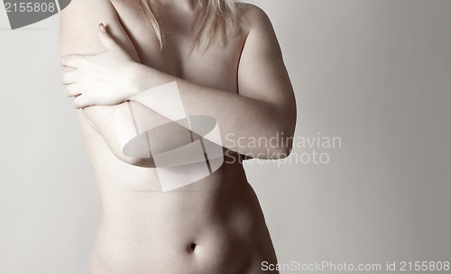 Image of Woman holding her breast