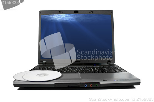 Image of White cd`s on a laptop isolated. Nice rays of light on desktop.