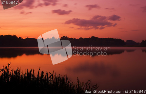 Image of Romantic sunset on the lake with fog