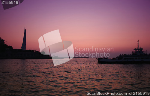 Image of Sunset sea with boat crossing the bay