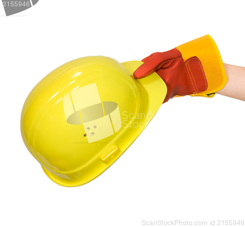 Image of Hand in glove holding a yellow hard hat isolated