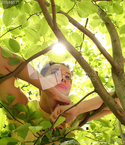 Image of Young beautiful woman outdoors in sunny park