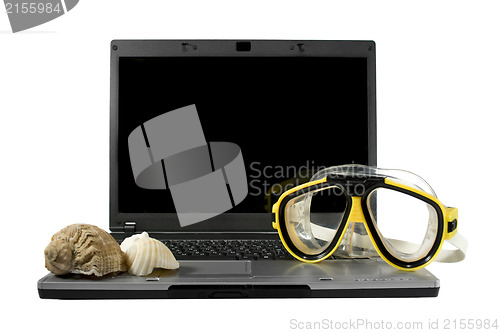 Image of Sea shells and Yellow diving mask on a laptop isolated. Sea trav