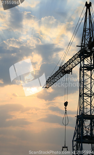Image of Construction crane silhouette with cool sunset background