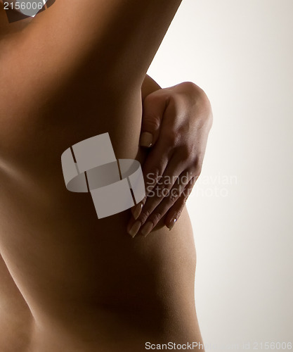 Image of Woman holding her breast