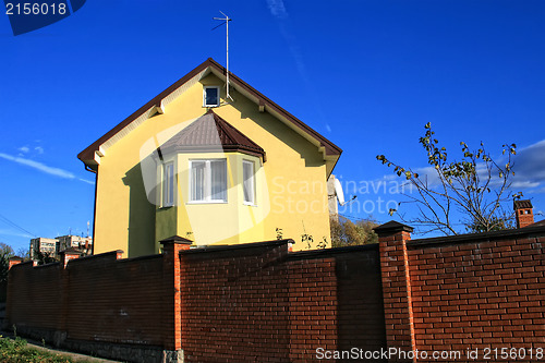 Image of Yellow house among blue sky