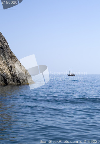 Image of Ship and several boats going into the sea.