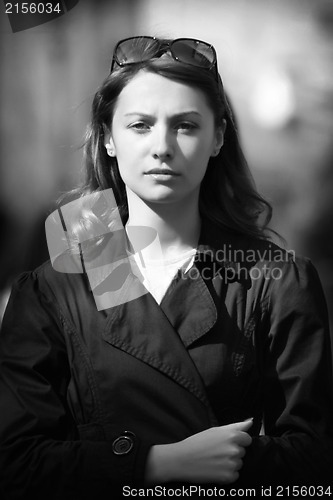 Image of Young woman among human rush in the city