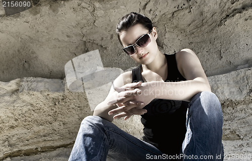 Image of Model sitting on the rocks. Urban style